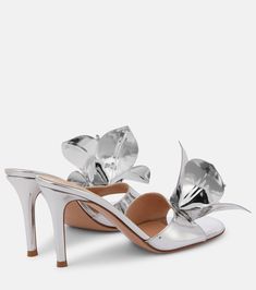 Elegant Slip-on Patent Leather Sandals, Luxury Slip-on Slides For Spring, Glamorous Leather Mules With Open Heel, Glamorous Leather Open Heel Mules, Spring High Heel Patent Leather Mules, Luxury Metallic Open Toe Mules, Luxury Metallic High Heel Mules, Metallic Patent Leather Sandals With Open Heel, Metallic Open Toe Patent Leather Sandals