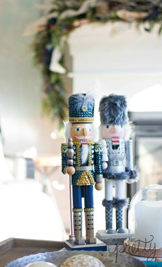 two nutcrackers are standing next to each other on a tray with donuts