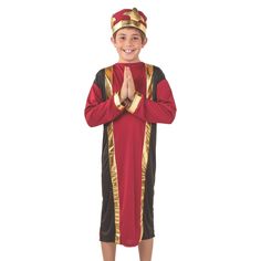 a young boy in a red and black costume standing with his hands folded up to the side