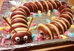 a very cute looking cake made to look like a caterpillar on tin foil