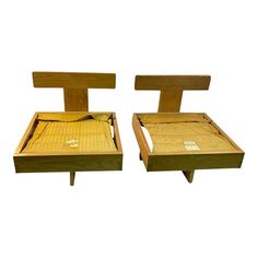 two wooden beds sitting next to each other