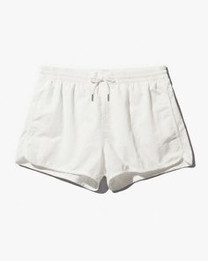 Our Swim Shorts in nylon poplin are designed with a regular fit, short leg and mesh lining for comfort and support. Made of recycled polyamide in a soft mid-weight with a slightly brushed finish.    Regular fit, short leg  Inside leg length size M 6.5 cm/2.6"  Fits true to size   Mesh lining for comfort and support   Elastic waistband with drawstring   Side seam pockets and back zip pocket for secure credit card storage   CDLP branded metal eyelets     Quick-drying   No-tag construction   Style Solid Nylon Short Bottoms, White Nylon Bottoms With Elastic Waistband, Solid Color Nylon Shorts, Functional Nylon Bottoms With Short Inseam, White Short Bottoms For Outdoor, Functional Summer Bottoms With Elastic Waistband, White Drawstring Bottoms For Outdoor, Solid Color Nylon Shorts With Functional Drawstring, White Nylon Go-dry Shorts