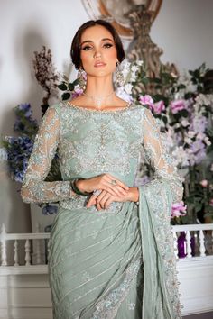 Pakistani Bridal Outfit in Premium Net Saree Style is an elegant attire that will give the bride a unique elegant look on the big day. Bridal Saree is emblazoned with embroidery, tilla, sequins, beads, and silverwork, making it a perfect choice to have a stylish look at the wedding. Embellished Blouse: The beautiful blouse in premium net fabric has an alluring sea-green shade. This perfectly stitched net blouse is adorned with hand-crafted details of embroidery, tilla, sequins, and pearls, givin Semi-stitched Chinon Blouse Piece For Wedding, Unstitched Embellished Wedding Blouse Piece, Unstitched Embellished Blouse Piece For Wedding, Wedding Embellished Unstitched Blouse Piece, Elegant Pre-draped Saree For Wedding And Eid, Embellished Blouse Piece With Traditional Drape For Wedding, Traditional Drape Embellished Blouse Piece For Wedding, Wedding Embellished Pre-draped Saree In Chinon, Fitted Pre-draped Saree With Zari Work For Wedding