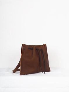 "Brown medi leather crossbody bag minimalist, Handmade leather bag, hygge leather bags, women crossbody bag, ethical bags, sustainable gifts. Cognac brown leather Origen bag Medium size. The origin collection is the simplest and purest of all my designs, the high quality of the leather and its simple lines make each bag special and unique. The medium origin leather bag is your perfect size for your everyday, traveling or going out. You can carry it over the shoulder or across the body, since the Minimalist Leather Shoulder Bucket Bag, Minimalist Leather Crossbody Bucket Bag, Minimalist Crossbody Hobo Bag, Everyday Vegetable-tanned Crossbody Shoulder Bag, Everyday Vegetable-tanned Crossbody Satchel, Minimalist Textured Leather Shoulder Bag, Minimalist Leather Shoulder Bag, Vegetable-tanned, Minimalist Leather Hobo Bag, Minimalist Soft Leather Crossbody Satchel