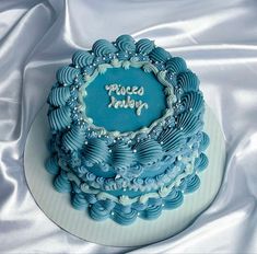 a blue and white cake with frosting on it