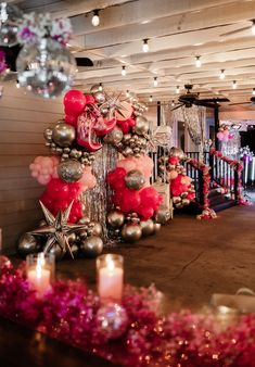 a room decorated with balloons, candles and decorations