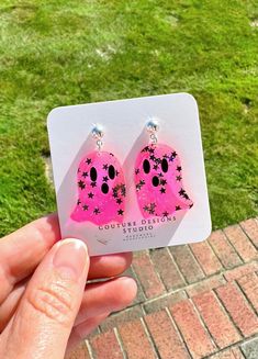 These Neon Pink Twinkle Ghost Earrings are sure to make a statement this Halloween! I absolutely LOVE how fun, whimsical and ultra girly these little ghosts are! They are made using acrylics that include a transparent neon pink and black holographic star ghost complete with matte black eyes and mouth. The total length of these earrings measure 1.5 inches tall and 1 inch wide. They are set using your choice of Stainless Steel Silver or Gold Ball Posts with silicone rubber backings OR nickel free and lead free ear wires (suitable for even sensitive ears) in a silver, gold, antique gold or gunmetal finish. Each pair of earrings come shipped attached to an earring card and sealed in their own clear packaging. All earrings purchased from my shop ship in a box so they arrive safely to you. Novelty Hypoallergenic Party Earrings, Novelty Hypoallergenic Earrings For Party, Hypoallergenic Novelty Party Earrings, Hypoallergenic Novelty Earrings For Party, Playful Halloween Earrings As A Gift, Playful Halloween Earrings For Gift, Playful Halloween Earrings For Gifts, Pink Dangle Jewelry For Halloween, Handmade Pink Jewelry For Halloween