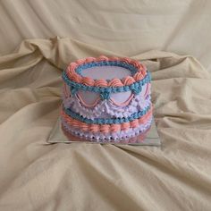 there is a cake with pink and blue decorations on it