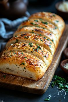 sliced loaf of bread sitting on top of a wooden cutting board