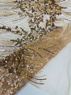 gold sequins and beads on white fabric