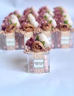 several small boxes filled with flowers on top of a table