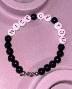 a black and white beaded bracelet with the words nice off you on it