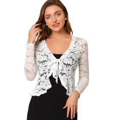 Opt for a decadent cover-up at your special occasion with this lace shrug. This stretchy lace cardigan gives the perfect balance to longer layers in a waist-defining cut with a tie front. A must-have in your clothing wardrobe. Constructed in a classic shrug silhouette, this charming piece benefits from an open neck and elegant long sleeves with ruffles. Intricate design details include satin binding around the front and hem and a floral lace design. Pair with a sleeveless dress, spaghetti strap, Sheer Shrug, Cropped Shrug, Lace Shrug, Lace Bolero, Bolero Shrug, Shrug Cardigan, Women's Tie, Lace Cardigan, Womens Tie