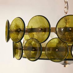 a chandelier made out of wine glasses hanging from it's sides,