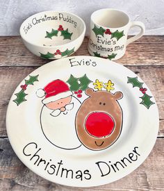 two christmas plates with santa claus and reindeer faces on them, one is holding a coffee mug