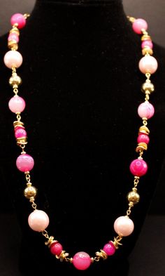 "This necklace is truly enchanting especially if you love the colors of pink and more pink!  The necklace features bold striped pink agate beads and light pink glass pearls along with gold metal beads and jade stone in many different colors of pink surrounded by wavy gold etched metal beads both small beads and large gold beads.  The necklace in finished with a gold chain and a lobster clasp.  Necklace is 27\" long. You have a choose of 2 earrings--(A) 3-pink jade stone beads with wavy discs ins Pink Necklace Set, Different Colors Of Pink, Jewelry Pearls, Stone Necklace Set, Pink Jade, 2 Earrings, Small Beads, Clasp Necklace, Gold Necklace Set