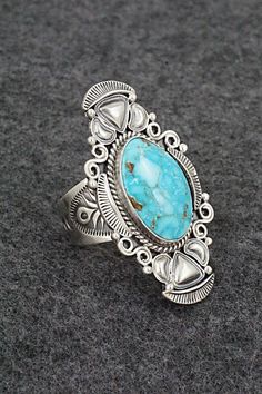 This natural Kingman turquoise and brushed-finish sterling silver ring was made by Navajo silversmith Derrick Gordon. The back is stamped sterling.Size: 9Length: 1 3/4"Width: 1"Free shipping on all orders! We ship with USPS and always include tracking. All orders ship within a day of payment.Returns are accepted up to 30 days after you receive your order. Just send us a message. Our shop offers cash back or store credit. The item must be returned in new condition. Bohemian Engraved Turquoise Ring In Sterling Silver, Oval Engraved Turquoise Ring In Sterling Silver, Oval Turquoise Engraved Ring In Sterling Silver, Engraved Oval Turquoise Ring In Sterling Silver, Western Sterling Silver Turquoise Ring With Patina, Bear Carving, Kingman Turquoise, White Buffalo, Pearl Chain