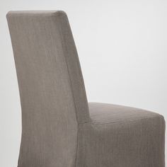 a close up of a chair with a white wall in the background