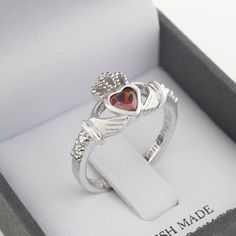 For any important person in your life born in January, this Claddagh inspired birthstone ring is a perfect gift. The hands of friendship, the crown of loyalty and the heart of love. The January birthstone, garnet, is said to evoke trust and friendship. Set with the unique and dazzling garnet stone, this piece displays the classical Claddagh symbol in a sterling silver band. - Perfect for her on her birthday - CZ centre stone - Symbolizing love, loyalty and friendship - Handcrafted in Ireland in Claddagh Symbol, Silver Claddagh Ring, Irish Ring Claddagh, Irish Rings, Claddagh Rings, Irish Jewelry, Garnet Stone, Sterling Silver Bands, Birthstone Ring