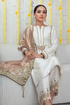 An ethereal Raw Silk ensemble featuring minimal zardozi embroidery beautifully contrasted with Rose Gold dupatta featuring beads, sequins, pearls, dabka, resham, cutwork and contrasting applique work details, finished with handmade tassels. This outfit is paired with cutwork and appliqued work hand embroidered culottes to complete the look. Shirt Fabric: Pure Raw Silk Shirt Color: Ivory Shirt Length: 40" Pant Fabric: Pure raw silk Pant Color: Ivory Dupatta Fabric: Pure Soft Tissue Dupatta Color: Designer Outfit, Pakistani Wedding Outfits, Kurti Neck, Pakistani Dresses Casual, Pakistani Fashion Party Wear, Salwar Kamiz, Pakistani Bridal Dresses, Simple Pakistani Dresses, Embroidery Suits Design