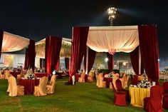 an outdoor banquet setup with red and yellow linens