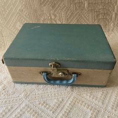 "The box measures 14 3/4\" long, 11\" wide, and 5 3/8\" tall. The interior is 4\" deep. I have always collected these small cases for storage. They are versatile and interesting. This is a child's suitcase covered in paper with a blue top and bottom with a cream body. I say paper, but it is really more like a vinyl. The case is wood. There is a metal locking latch and blue plastic handle. There is not a key. The interior is lined in a coordinating paper. I believe the box is wood and it is struc Vintage Rectangular Storage Cases, Vintage Rectangular Case For Storage, Vintage Rectangular Case For Gifts, Vintage Rectangular Case For Gift, Vintage Rectangular Cases For Gifts, Doll Case, Suitcase Cover, Overnight Travel Bag