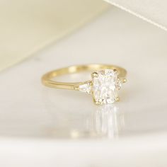 a yellow gold engagement ring with an oval cut diamond