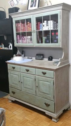 an old china cabinet with glass doors and drawers