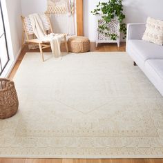 a living room with a white rug and wooden furniture in the corner, next to a window