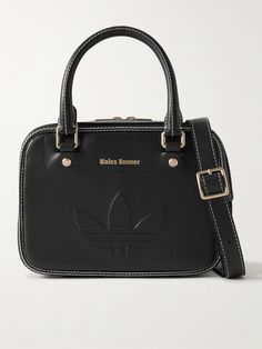 This leather messenger bag is part of adidas Originals' capsule with Wales Bonner. Embossed with the signature 'Trefoil' logo, it features retro-inspired contrasting topstitching and sleek gold-tone hardware. Carry yours cross-body using the adjustable shoulder strap, and stow your phone, cardholder, sunglasses and compact inside. Rectangular Leather Shoulder Bag For Streetwear, Leather Crossbody Bag For Streetwear, Luxury Leather Bags For Streetwear, Leather Shoulder Bag For Streetwear With Zipper, Functional Leather Bags For Streetwear, Black Adidas Bag For Everyday Use, Sporty Leather Crossbody Bag, Sporty Rectangular Leather Bag, Sporty Leather Shoulder Bag With Zipper Closure