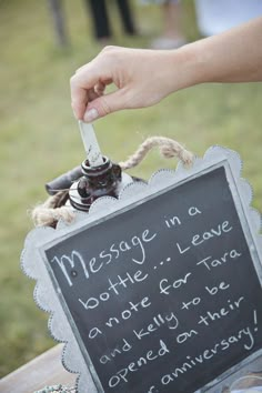 a person holding a knife in front of a chalkboard sign that says message in a bottle