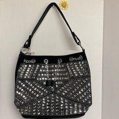 Rhinestone Bling Drawstring Hobo Make A Sparkling Statement Of Gorgeous Style Anywhere You Go With This Rhinestone Bling Hobo Bag. It Is Truly Stunning. * 11l Single Strap And 22l Adjustable Shoulder Strap. * Faux Leather With Lined Interior. * 2 Interior Slip Pockets & 1 Zip Pocket. * Drawstring And Magnetic Snap Closure. * Silver Hardware. * Tablet Compatible (Std. Size 8-10in). Approximate Size: 11.5l X 12h X 5w Silver Metal Shoulder Bag For Everyday Use, Silver Rhinestone Shoulder Bag For Night Out, Silver Bling Bags For Night Out, Glamorous Silver Shoulder Bag With Rhinestones, Glamorous Silver Metal Bag, Glamorous Silver Metal Bags, Glamorous Black Shoulder Bag With Rhinestones, Glamorous Silver Shoulder Bag With Bling, Glamorous Black Rhinestone Shoulder Bag