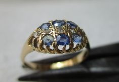 Quality early Edwardian 18ct solid gold diamond and sapphire gemstone ring. The head of the ring is marquise shaped, size 10.0mm{North to South} x 12.0mm{East to West} and is encrusted with rows of light blue sapphire gemstones and diamond gemstone chips, sandwiched between. All of the gemstones are in top condition and exposed to the ring's reverse side to allow the light to shine through to make them glow, also for easy cleaning access. The shank is straight and displays a full striking Birmingham 18ct gold assay hallmark for the year 1903 on its inside circumference. Size 'R-S'{UK}, 9.25{US}. Weighs 3.1 grams. Superb condition throughout with genuine precious gemstones, no repairs and full authentication for its year of manufacture --- a pretty Edwardian example. Victorian Sapphire Ring With Diamond Oval Shape, Antique Sapphire Ring With 17 Jewels, Victorian Gold Sapphire Ring With Diamond, Victorian Sapphire Ring With Diamond In Gold, Antique Oval Sapphire Diamond Ring, Victorian Oval Sapphire Ring With Diamond, Antique Yellow Gold Sapphire Ring With Rose Cut Diamonds, Antique Sapphire Diamond Ring With Rose Cut, Antique Blue Diamond Ring With Rose Cut