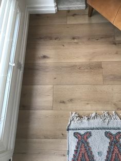 a wooden floor with a rug on top of it