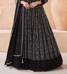 COLOR : Black FABRIC : Top - Pure Georgette, Dupatta - Net WORK : Silk Thread Embroidery, Digital Print, Sequins, Lace Border OCCASION : Party Wear, Festival READY-TO-WEAR : No STITCHING : Available as semi-stitched fabric, can be stitched using standard size option (+$30). Note: There might be a slight color variation due to lighting and flash used during photoshoot. The bright shade seen is the best closer view of fabric's color. Semi-stitched Embellished Black Anarkali Set, Fitted Anarkali Gown With Intricate Embroidery, Fitted Floor-length Anarkali Set With Intricate Embroidery, Intricately Embroidered Fitted Gown For Eid, Fitted Embroidered Gown For Eid, Fitted Anarkali Set With Intricate Embroidery In Georgette, Embroidered Semi-stitched Maxi Length Lehenga, Fitted Georgette Embroidered Fabric For Formal Wear, Fitted Georgette Embroidered Fabric For Formal Occasions