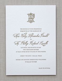 a wedding card with an ornate monogrammed design