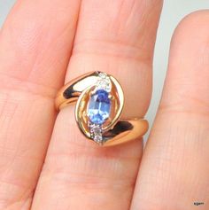 Elegant Style, Genuine, 14k Solid Yellow Gold Ring, with .50ct. Oval Cut Tanzanite in Lavender Blue color, and genuine Diamonds. The oval shaped center stone is 6mm x 4mm and the face of the ring is about 13mm long by 10mm wide. This Awesome Estate ring is a size 5 3/4 Ring, resizable by your local jeweler, if need be. It weighs 3.7grams, tested and Hallmarked 14k. Accented with 4 points of round cut diamond accents, prong set in white gold atop a yellow gold mount with a gorgeous free form desi Oval Tanzanite Diamond Ring For Anniversary, Yellow Gold Tanzanite Birthstone Ring For Anniversary, Gold Tanzanite Birthstone Ring For Anniversary, Oval Tanzanite Birthstone Ring, Formal Oval Tanzanite Birthstone Ring, Oval Tanzanite Diamond Ring For Gift, Oval Tanzanite Diamond Ring As A Gift, Lavender Blue Color, Plant City