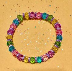 Handmade Easter beaded bracelet. Sparkling crystal-like spacer beads with clear pink, yellow, green, blue, and purple beads. Perfect gift for Easter, Mother's Day, or just enjoy it all year. Intended for adults, but would fit loosely on a child's arm. Stretch material used and no clasp. Triple knotted and glued to securely stay together with clear elastic stretch cord. Rainbow Crystal Bracelet With Colorful Round Beads, Rainbow Faceted Beads Bracelet For Jewelry Making, Rainbow Faceted Beads Bracelets, Rainbow Faceted Round Beads Bracelets, Colorful Crystal Bead Bracelet, Colorful Crystal Beads Bracelet, Multicolor Crystal Bracelet With Faceted Beads, Spiritual Multicolor Crystal Bracelet With Faceted Beads, Rainbow Crystal Bracelet With Round Beads For Gift