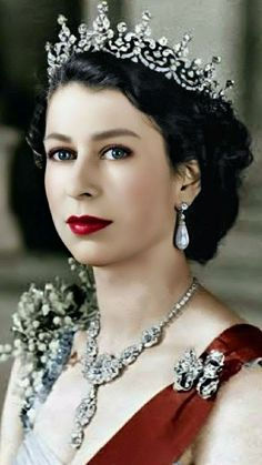 an old photo of a woman wearing a tiara and holding flowers in her hand