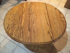 a wooden table sitting on top of a tiled floor