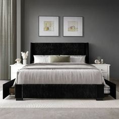 a bedroom with gray walls and white bedding, two framed pictures on the wall