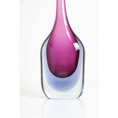 a purple vase sitting on top of a white table