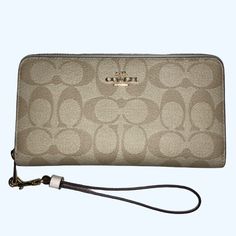 Nwt Coach - Signature Canvas Long Zip Around Wallet In Im / Light Khaki / Chalk Color W/ Wristlet Strap -This Exact Color Combination Not Available On Coach Website -The Stock Photos / Last Two Pictures Are From A Coach Website. Per Coach Website: Length: 7.5" Height: 4.0" Width: 1.0" -Detachable Wrist Strap -Inside Zip Coin Pocket -12 Credit Card Slots (6 On Each Side) -Full-Length Bill Compartments Elegant Handheld Wallets For Daily Use, Elegant Handheld Wallet For Daily Use, Coach Wallet With Zipper Closure For On-the-go, Coach Clutch With Zipper For Daily Use, Elegant Rectangular Wallets For On-the-go, Elegant Handheld Wallets With Card Slots, Elegant Handheld Wallet With Card Slots, Elegant Handheld Travel Wallets, Elegant Handheld Travel Wallet