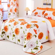 a bed with orange and white flowers on it