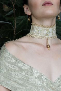 The Flora Choker is handmade by Message in Stone. Gemstones are: *Peridot - stone of compassion, equality, balance, creativity *Yellow Jade - soothing, harnessing of potent fire energies, enhances senses of self *Rose Quartz - enhances love, peace Fabric is woven in Vietnam. Lace is vintage. Metal pendant is brass, hand-made in Ethiopia. All other metals are gold plated brass. All metal will form a patina over time. Bohemian Beige Jewelry For Meditation, Bohemian Beige Jewelry For Wedding, Bohemian Beige Wedding Jewelry, Yellow Bohemian Jewelry With Artistic Design, Traditional Cream Necklace As A Gift, Traditional Cream Jewelry Gift, Traditional Cream Jewelry For Gifts, Traditional Cream Necklace For Gift, Cream Adjustable Spiritual Jewelry