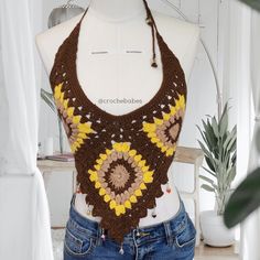 a mannequin wearing a crocheted top with sunflowers on it