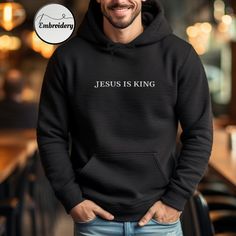 Embroidered Jesus Is King Hoodie  High-quality embroidery - Made from premium materials, this pullover hoodie ensures both warmth and comfort. The classic design makes it a versatile addition to your Christian wardrobe. Christian Hoodie Features: * 50% pre-shrunk cotton, 50% polyester * Double-lined hood with matching drawcord * Front pouch pocket * High quality embroidery with Bible verse * Available in a range of sizes and colors, it's suitable for both men and women. Christian Clothing: I love adorning shirts with scripture, as it helps spread the message of the Good News of Christ. Each Bible verse woven into fabric has the power to convey profound truths, speaking to anyone who encounters them. This hooded sweatshirt is made especially for you as soon as you place an order, which is w Hooded Embroidered Sweatshirt For Winter, Hooded Winter Sweatshirt With Embroidered Graphics, Embroidered Hooded Sweatshirt For Winter, Winter Hooded Sweatshirt With Embroidered Graphics, Long Sleeve Hoodie With Letter Embroidery For Streetwear, Streetwear Long Sleeve Hoodie With Letter Embroidery, Winter Embroidered Crew Neck Hoodie, Fleece Hoodie Sweatshirt With Embroidered Graphics, Embroidered Fleece Hoodie Sweatshirt