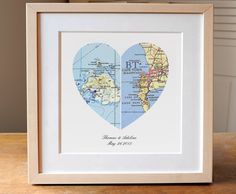 a heart shaped map with the words handmade in blue and white, on a wooden table