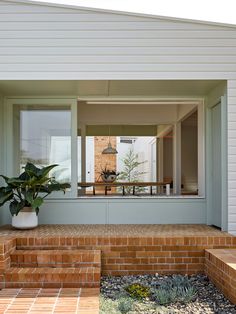 a house with brick steps leading up to the front door and back porch area,