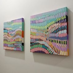 two paintings on the wall one is multicolored and the other is made out of colored pencils